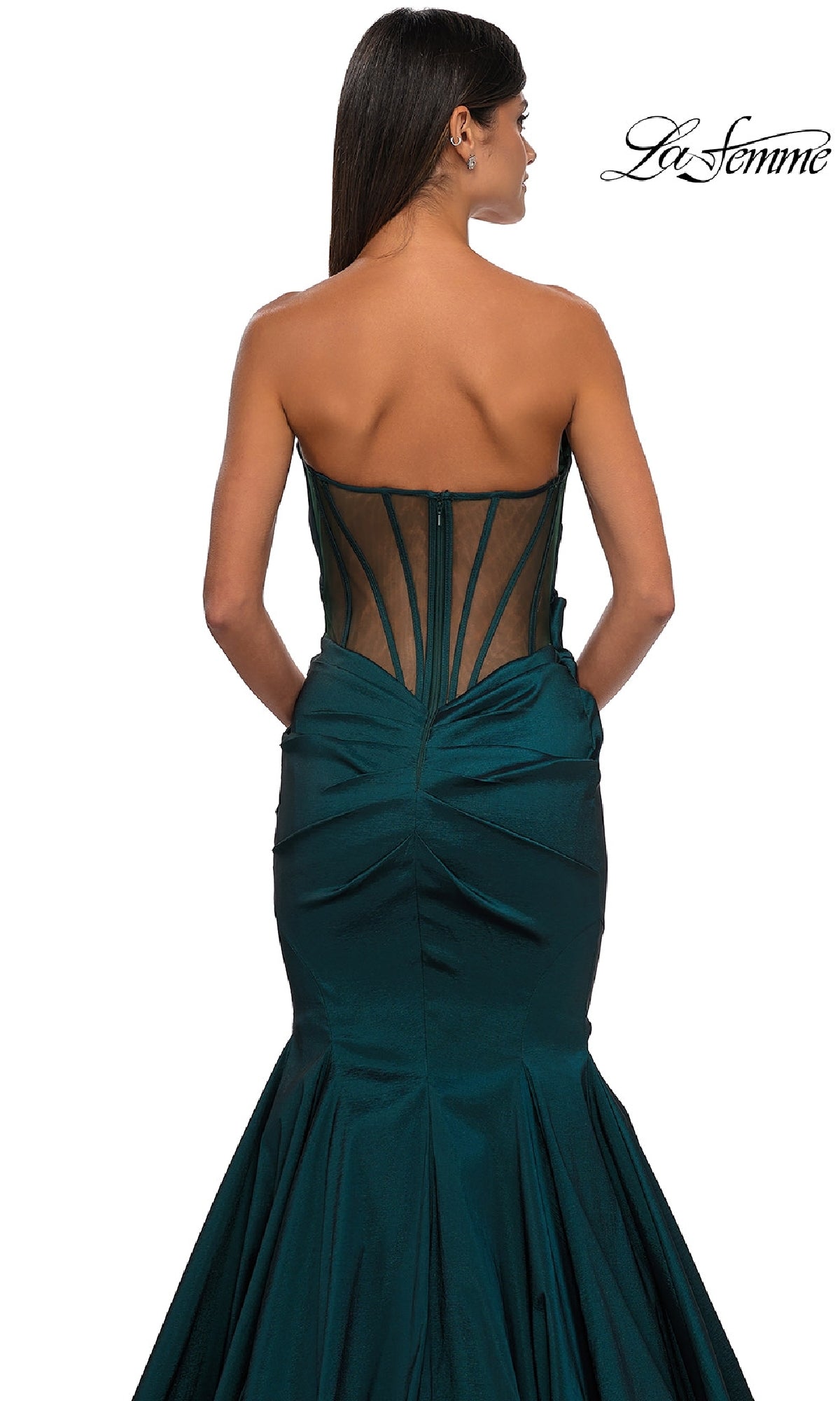 A woman is shown from behind in the La Femme 32791 strapless long mermaid prom dress, dark green with sheer black back paneling, against a white background.